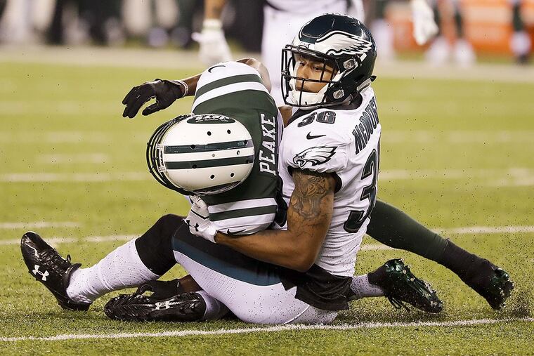 Eagles cornerback Dexter McDougle stops New York Jets wide receiver Charone Peak during a preseason game.