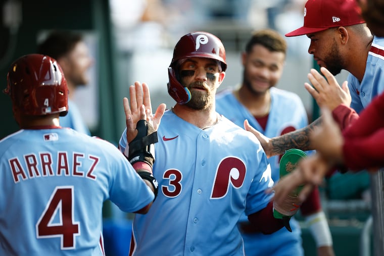 Phillies' Bryce Harper celebrates his first inning run with Luis Arraez.