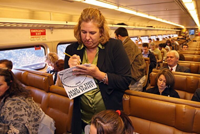 Diane Byrne works on her Sudoku puzzle as she lines up to get off the
R3 at her station in Philly. ( Michael Bryant / Staff Photographer )