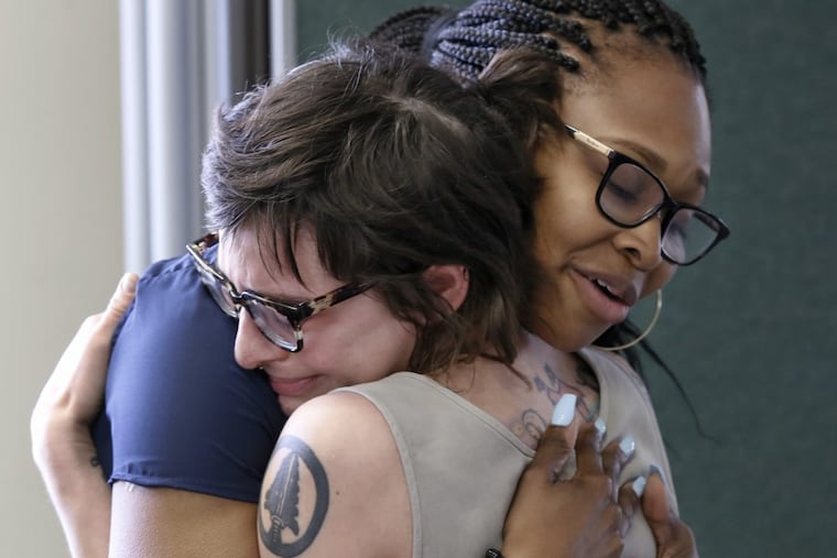 Emily Hill of Philadelphia (left) cries as she is hugged by Jhas Williams-Wood during a rehearsal for “This Is My Brave.”