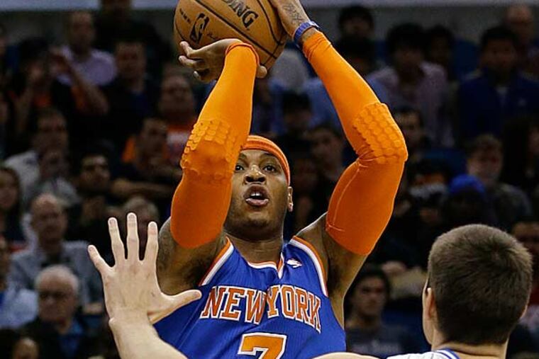 New York Knicks' Carmelo Anthony takes a shot over Orlando Magic's Nikola Vucevic (9) during the first half of an NBA basketball game, Saturday, Jan. 5, 2013, in Orlando, Fla. (John Raoux/AP)