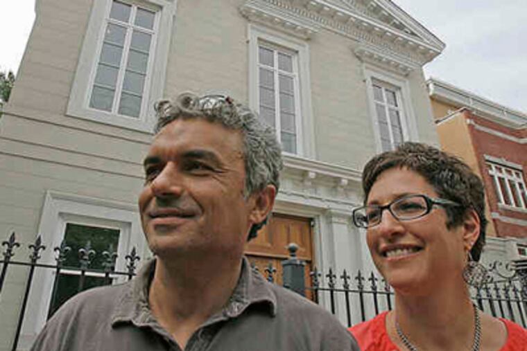 Isaac and Naomi Ohayon stand in front of the structure that has long fascinated them. All the house needs now is a buyer. (Akira Suwa / Staff Photographer)