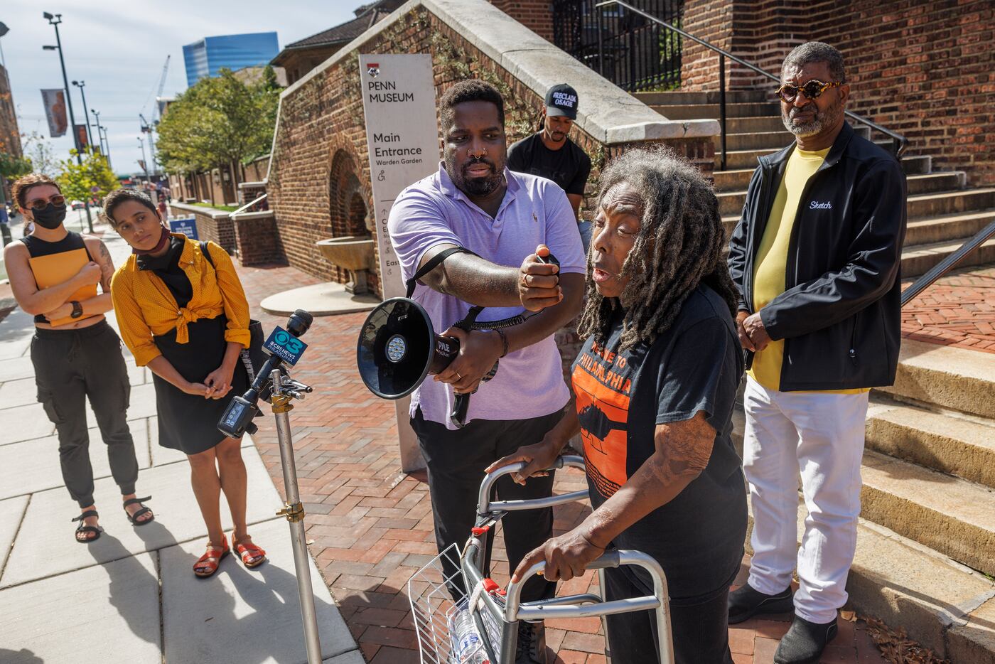 Ramona Africa speaking at an August 2023 news conference. She is the only adult survivor from the MOVE bombing. Holding a megaphone is aAliy Muhammad, an activist and journalist who has written about the MOVE remains held at Penn.
