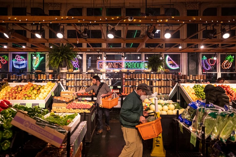 Customers browsing through Iovine Brothers Produce at Reading Terminal Market in Philadelphia.
