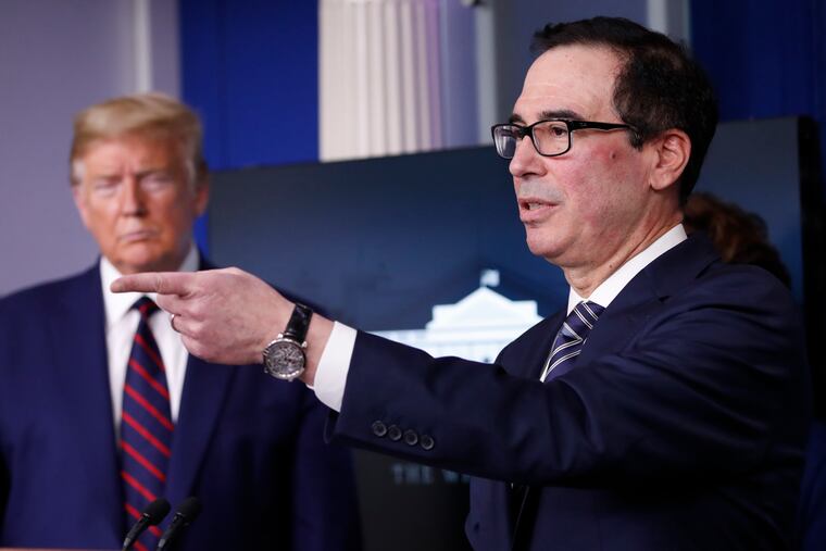 President Donald Trump listens as Treasury Secretary Steven Mnuchin speaks during a White House briefing on Thursday.