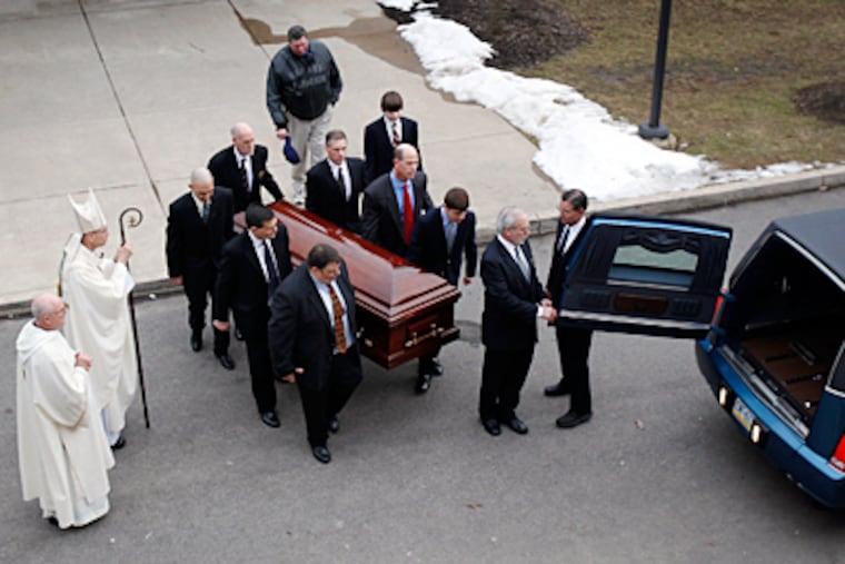 Pallbearers including Joe Paterno's son Scott (front left) carry his casket to a hearse before the procession through the Penn State campus. "It was simple in a Joe way," former Nittany Lions star Ki-Jana Carter said of the funeral. (David Maialetti / Staff Photographer)