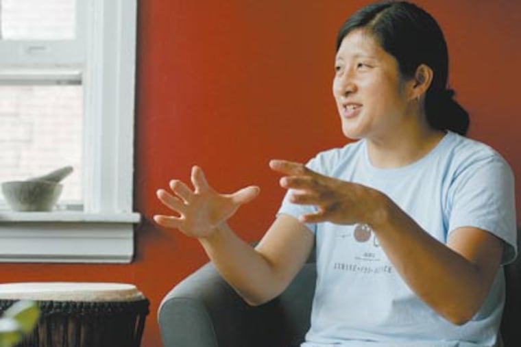 Kathy Shimizu has created the Mid-Autumn Festival poster since 2006, and it has become highly anticipated. "I try to put something in it that's personal, but it's not about putting my artwork on the street," she said. (Michael Bryant / Staff Photographer)