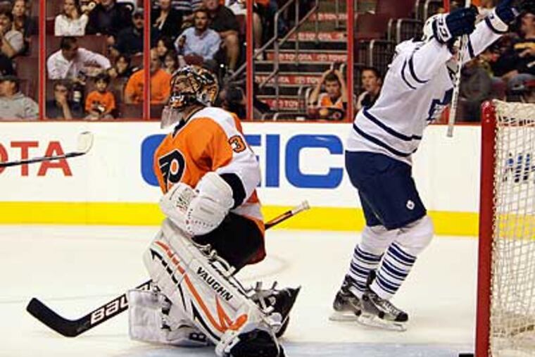 Ilya Bryzgalov reacts while Colby Armstrong celebrates after Toronto scores in the second period. (David Maialetti/Staff Photographer)