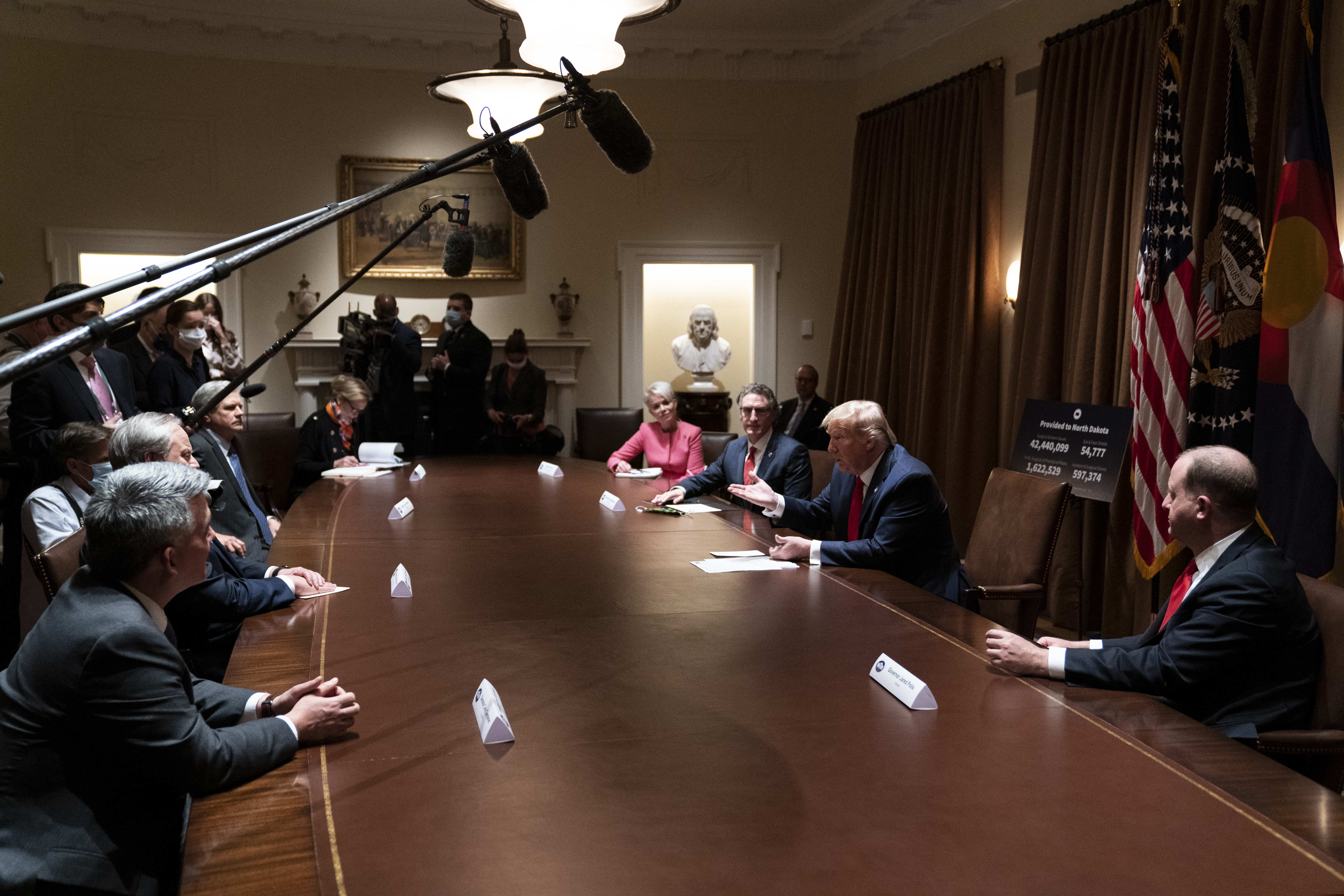 President Donald Trump speaks during a meeting with North Dakota Gov. Doug Burgum and Colorado Gov. Jared Polis on the coronavirus response, in the Cabinet Room of the White House.