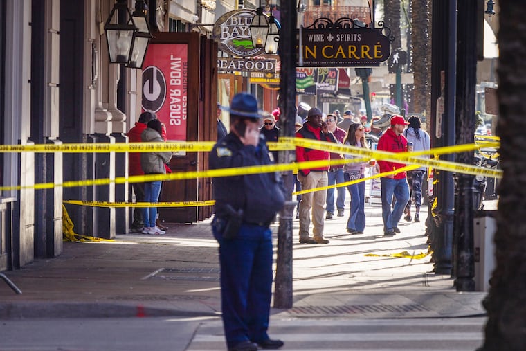 Officers stand near the intersection of Bourbon and Canal streets as pedestrians return to the French Quarter on Thursday, January 2.