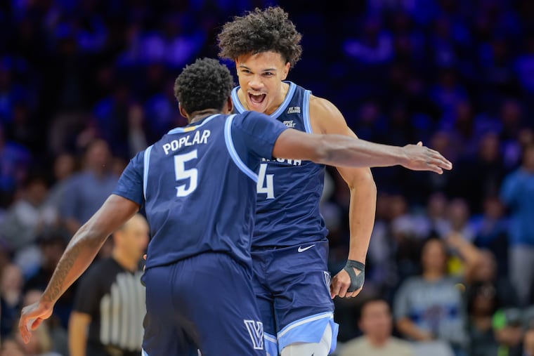 Villanova guards Wooga Poplar and Tyler Perkins celebrate a Perkins three-pointer against Temple on Saturday.