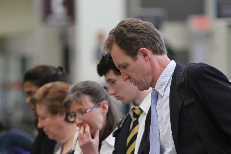 US Airways passengers at Philadelphia International. Airline officials say service will improve with the merger.