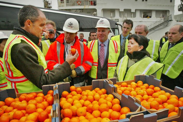 FRANCISCO CAMPS, president of the Spanish province of Valencia, visits Holt Logistics Corp., of Gloucester City, N.J. yesterday. Valencia is the largest exporter of clementines, known as the "Christmas fruit," in the world. Hundreds of boxes of clementines will be donated to Philabundance, the Delaware Valley's largest hunger-relief organization. At right is Martha Buccino, senior vice president of Philabundance.