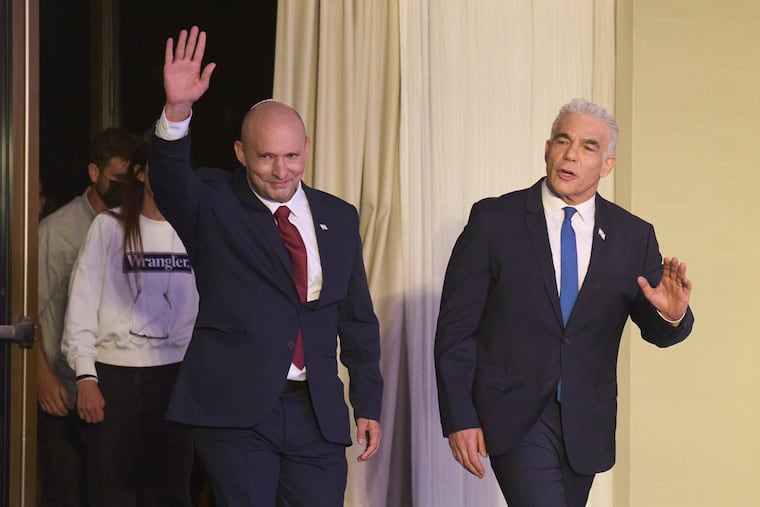 Former Israeli prime ministers Naftali Bennett, left, and Yair Lapid arrive to a joint press conference announcing that their parties will run together in the upcoming elections, in Herzliya, Israel, Sunday, April 26, 2026.