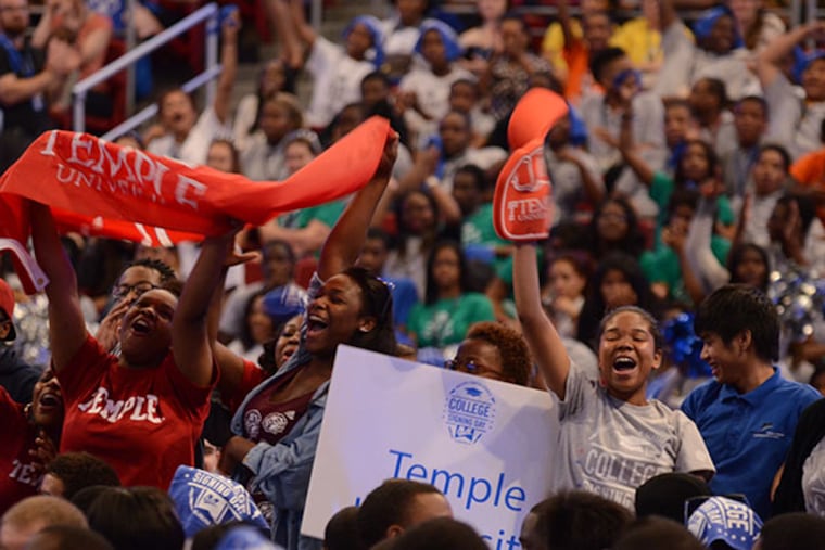 Graduates who will be attending Temple University cheer as they are announced during the Mastery Charter Schools College Signing Day ceremony at the Liacouras Center on Tuesday, June 3, 2014. (Andrew Thayer / Staff Photographer)