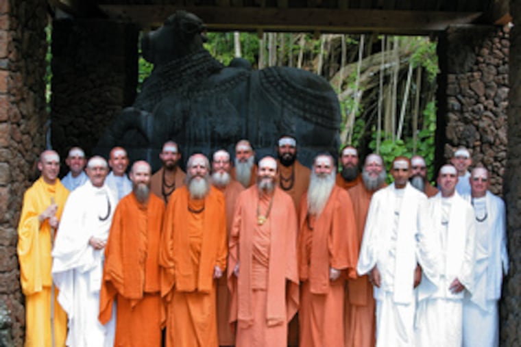 Hindu monks, many of them converts from abroad, pose before the monastery, which will take another decade to complete.