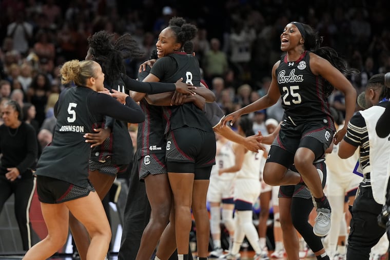 South Carolina players celebrate after defeating UConn in the Final Four, clinching Dawn Staley's fifth national championship game appearance.