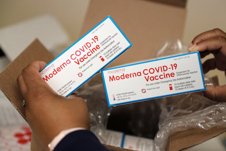 CAMcare Health Corporation nurse manager Latiayah Hudson holds a vial of the Moderna COVID-19 vaccine at CAMcare on Federal Street in Camden in December.