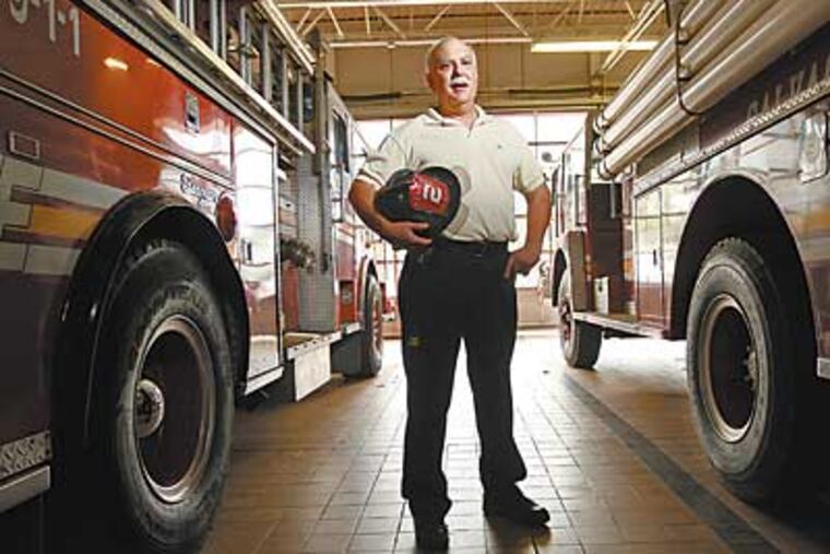 Firefighter Dan DiRenzo retired last week after 35 years with the Cherry Hill Fire Department. He was the first responder to the 1977 fire that destroyed the Garden State Park racetrack. (Michael Bryant/Inquirer)