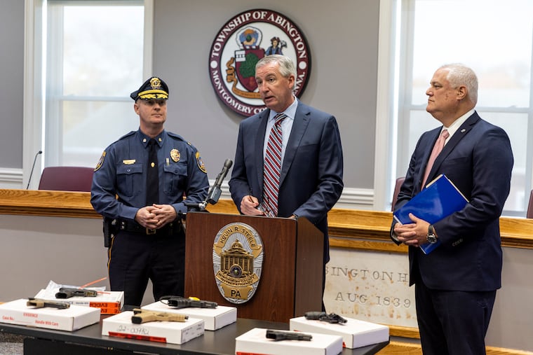 Montgomery County District Attorney Kevin R. Steele (center) along with Bucks County District Attorney Matt Weintraub (right) announced the arrests Thursday of five men involved in a three-county gun trafficking ring.