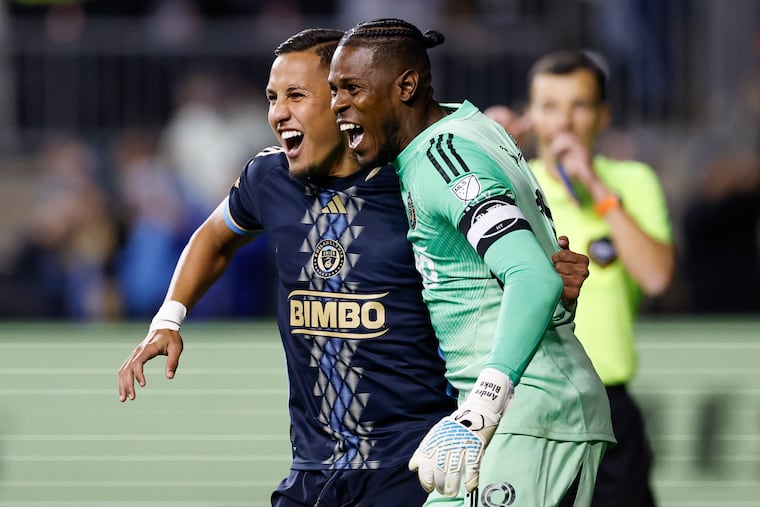 Union midfielder Jesús Bueno celebrates his penalty-kick goal with goalkeeper Andre Blake on Sunday night in Chester.