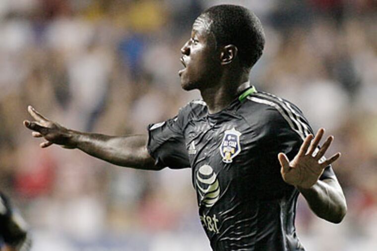 Seattle's Eddie Johnson celebrates after scoring the winning goal for the MLS All-Stars. (Elizabeth Robertson/Staff Photographer)