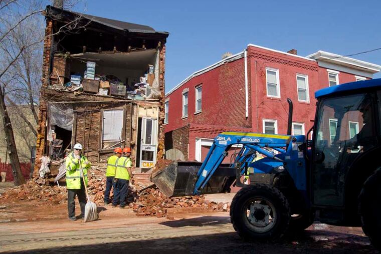 The Ali family complained for years that the city of Camden should have assisted them in making their home structurally sound after they knocked down the house next door. Late last night their home collapsed at 443 Line Street in Camden. Clean up continues on Mar. 9, 2015. (Charles Fox / Staff Photographer)