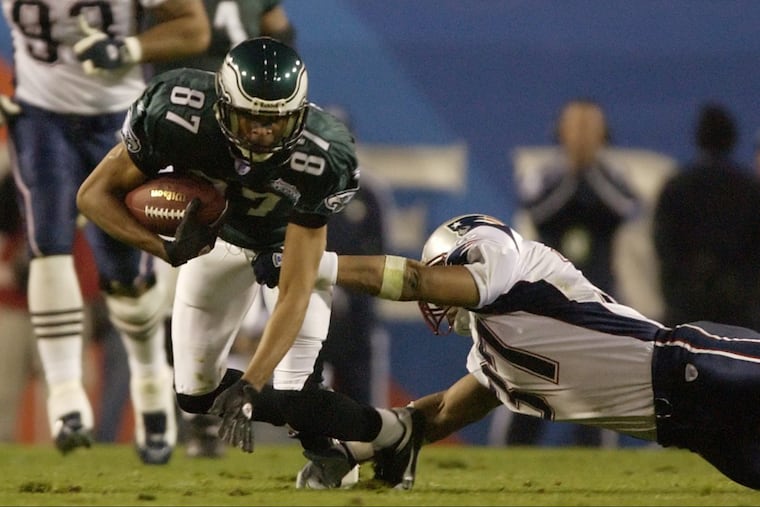 EAGL07MP12 67951 February 6, 2005 SUPER BOWL XXXIV Philadelphia Eagles vs. New England Patriots, Alltel Stadium, Jacksonville Florida — Eagles WR Todd Pinkston is tripped up be Patriots Rodney Harrison in the second quarter. Philadelphia Inquirer photo by Michael Perez.