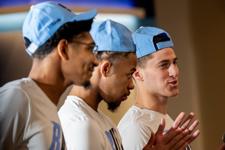 Villanova mens’ basketball players Jermaine Samuels Jr. (from left) Justin Moore and Collin Gillespie talk to supporters after the NCAA Selection Sunday watch event.