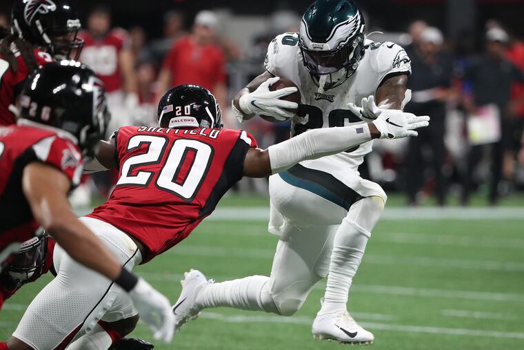 Eagles running back Miles Sanders tries to break a tackle by Atlanta Falcons defensive back Kendall Sheffield, left, in the 2nd quarter as the Philadelphia Eagles play the Atlanta Falcons in Atlanta, GA on September 15, 2019. .