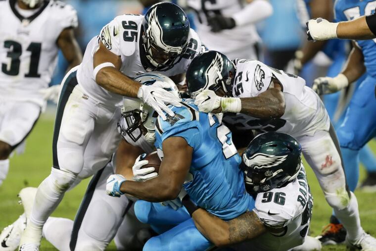 Philadelphia Eagles outside linebackers Mychal Kendricks and Nigel Bradham, and defensive end Derek Barnett, stop Carolina Panthers running back Jonathan Stewart during the third quarter at Bank of America Stadium in Charlotte, N.C., on Thursday, Oct. 12, 2017. The Eagles won, 28-23. (Yong Kim/Philadelphia Daily News/TNS)