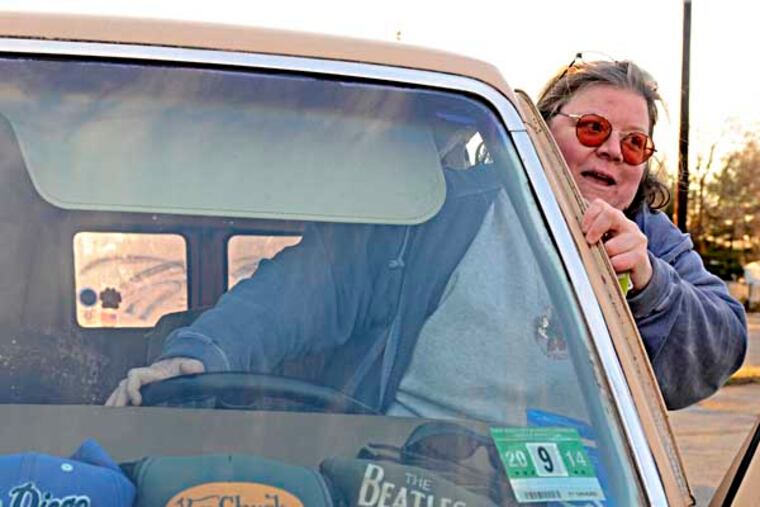 Beth Connolly is one of four South Jersey do-gooders being highlighted in Kevin Riordan column about folks who do good works with little recognition. She says goodbye to fellow volunteers after they delivered donations to her 1979 Ford Econoline van (parked at their church in Glendora December 27, 2013. The caps belonged to a good friend, Chuck Moorehead, who died in 2009. They bought the van together in 1998 (now has 275K miles). ( TOM GRALISH / Staff Photographer )