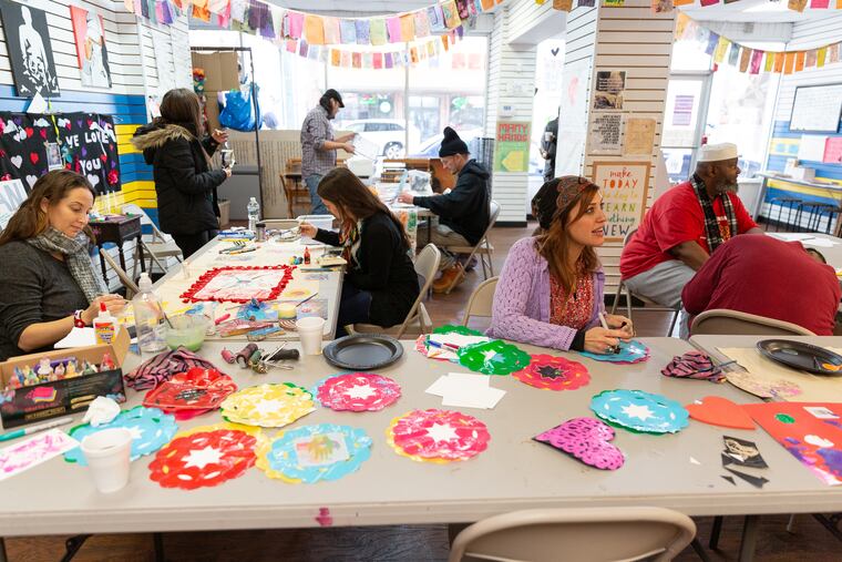 Community members participate in a patches and prayer flags workshop at the Kensington Storefront, February 6, 2019.