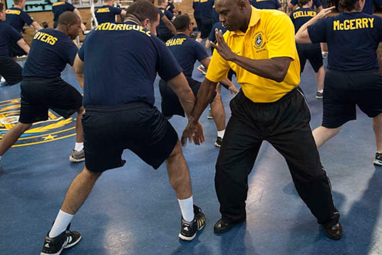 Officer Recruit Emmanuel Rodriguez practices defense tactics with instructor Stephen Dangerfield.