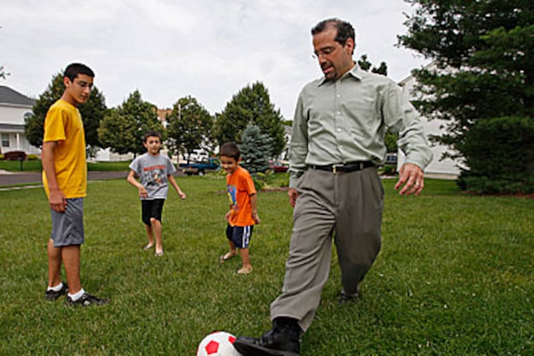 Joe Bisicchia (right) plays with his children in the front yard. (Michael S. Wirtz / Staff Photographer)