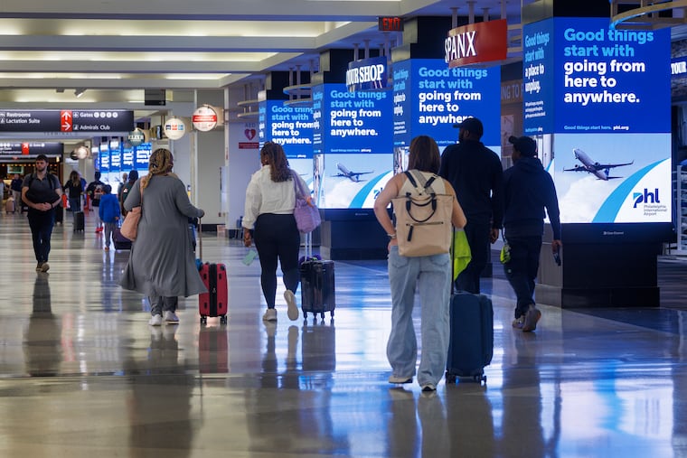 Travelers walk through Philadelphia International Airport in April.