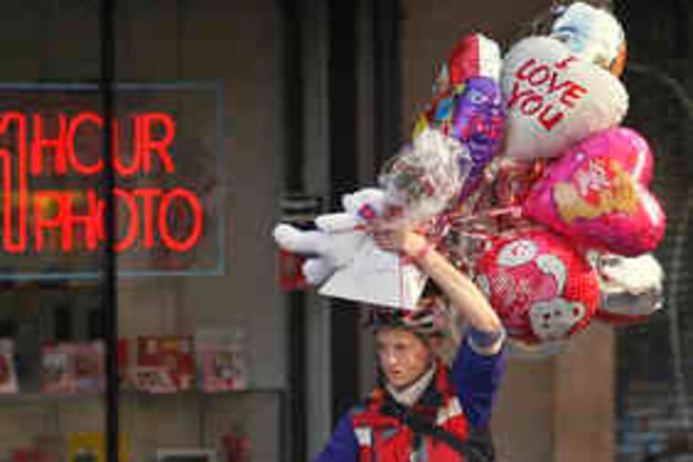 HERE COMES Valentine's Day, a bit early - it's not until Saturday - but these days we'll take love when we can get it and, yesterday, so did this cyclist at 6th and Market streets.