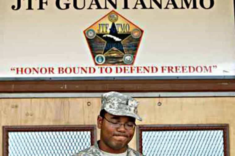 In this file photo, Lt. Lance Cagnolatti, public affairs office, stands at the entrance to the courthouse at Guantanamo Bay U.S. Navy Base in June 2007 in Cuba. (Peter Tobia / Inquirer)