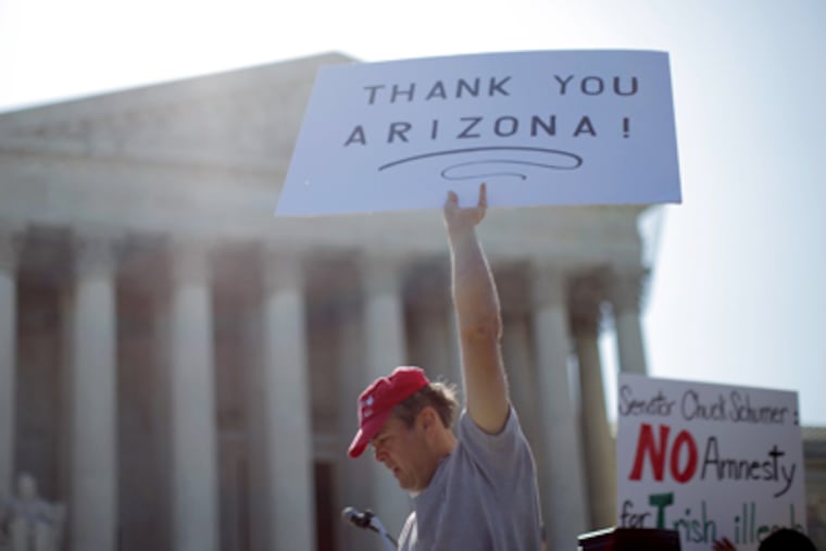 A supporter of Arizona’s "show me your papers" immigration law demonstrates in front of the U.S. Supreme Court. (Charles Dharapak / AP Photo)