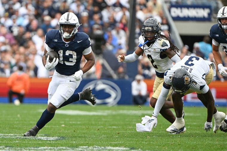 Penn State running back Kaytron Allen (13) runs away from Florida International defensive back Demetrius Hill (3) during the first half of their game on Saturday in State College.