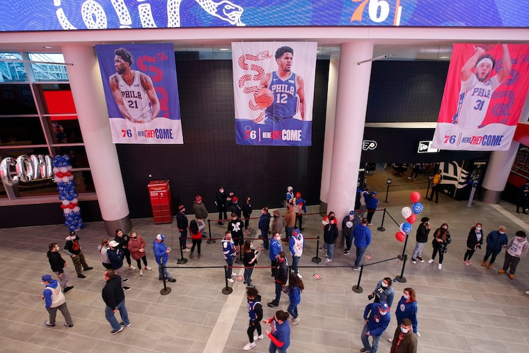 For the first time in more than a year, Sixers fans walk the Wells Fargo Center main concourse area before Sunday's game against the Spurs.