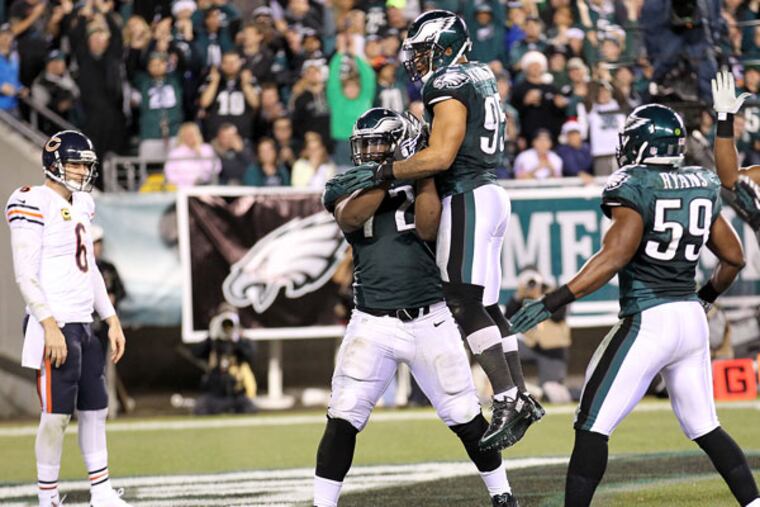 Cedric Thornton celebrates with his teammates after his third-quarter safety. (Yong Kim/Staff Photographer)