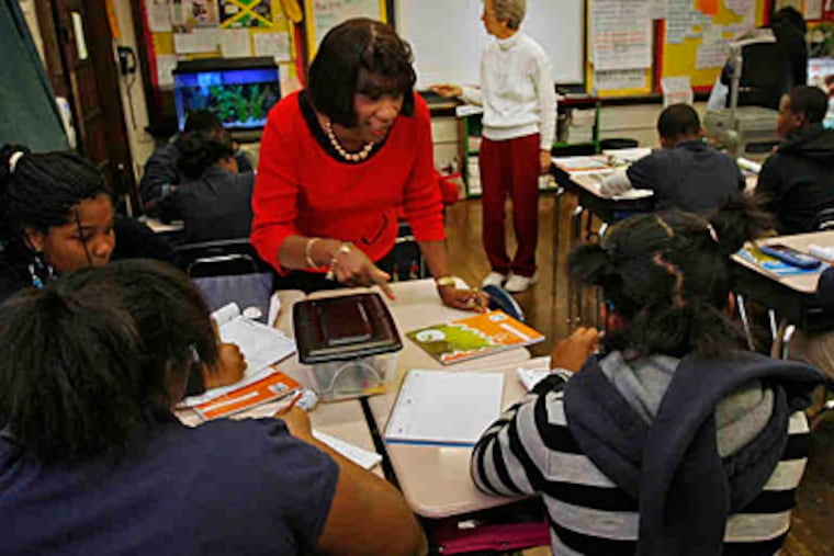 Reading teacher Eloise Overby (foreground) and math teacher Joanne Fidler work with students at Spring Garden School, which outperforms schools with similar student populations. (Alejandro A. Alvarez/Staff)