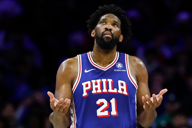 Sixers Joel Embiid grabs his side as he runs up court during a game against the Minnesota Timberwolves on April 3. Embiid recently underwent surgery for appendicitis.