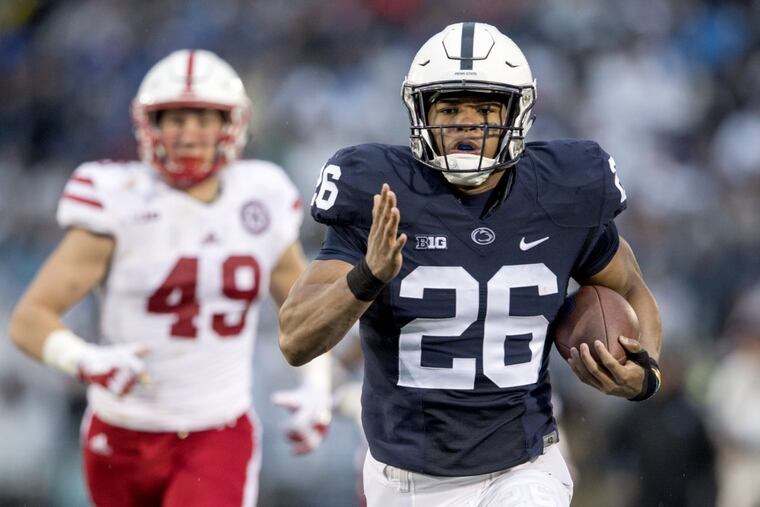 Penn State running back Saquon Barkley runs for a touchdown ahead of Nebraska defenders during an NCAA college football game Saturday, Nov. 18, 2017, in State College, Pa.