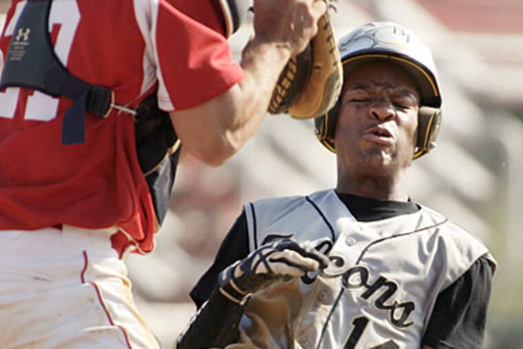 Burlington Township's Aaron Crichlow scores under the tag of Rancocas Valley catcher Garen Turner. (Elizabeth Robertson/Staff Photographer)