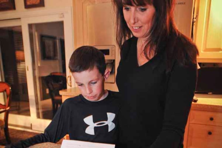 Nan Weinberg and her son, Cole a fifth grader at Johnson read a letter that Cole has been wait listed to attend Rosa Middle School. March 8, 2013 ( RON TARVER / Staff Photographer )