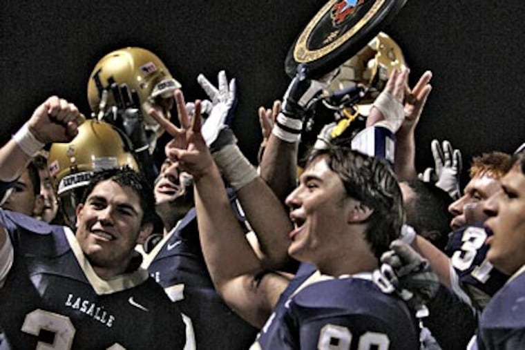 LaSalle players celebrate their third Catholic League Class AAAA championship (David M Warren/Staff Photographer)