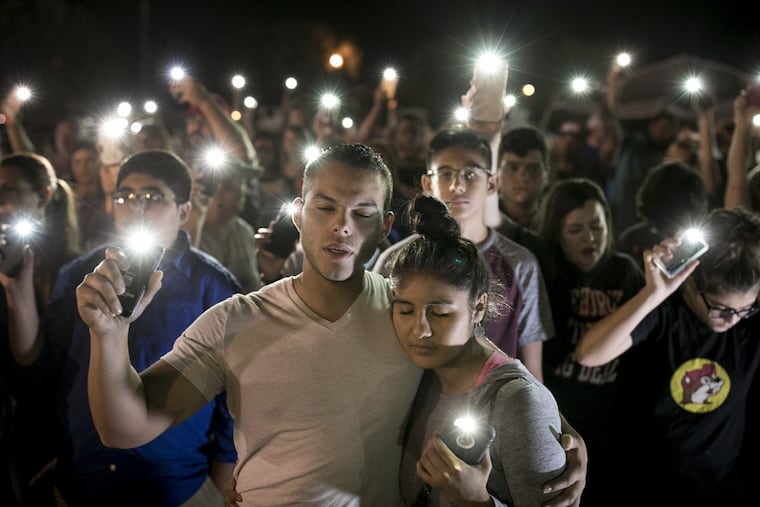 Matthew Mata and Erika Gonzalez participate in a memorial service for the victims of Sunday's church shooting in Sutherland Springs, Texas, Monday, Nov. 6, 2017.