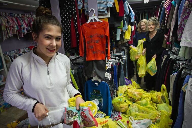 Katelyn Darrow sorts donations at Angels of God Clothing Closet in Pitman with help from volunteers Starr Tyrell (left) and Leslie Sadler. Darrow hopes to assemble 500 Easter baskets for children in need. (ALEJANDRO A. ALVAREZ / Staff Photographer)